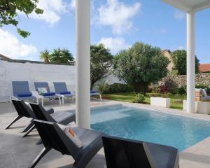 a swimming pool with lounge chairs and a swimming pool at Solar do Sabão - Your Gathering Place in Relva