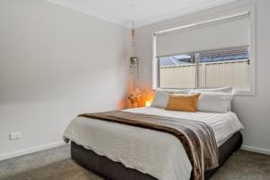 a bedroom with a large bed with a window at Casa de Soleil New Modern Home Central Location in Worragee
