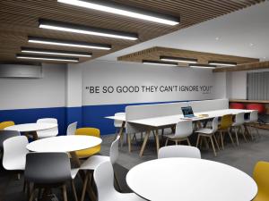 a classroom with white tables and yellow chairs at For Students Only - Student Castle Cambridge in Chesterton