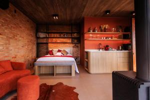 a bedroom with a bed and a brick wall at Cabana Morada nas Nuvens in Pinto Bandeira