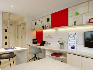 a room with a desk with a laptop on it at For Students Only - Student Castle Cambridge in Chesterton +3 photos