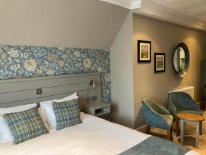 Ένα ή περισσότερα κρεβάτια σε δωμάτιο στο Tullie Inn