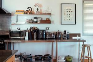 a kitchen with a counter top with a microwave at Vince's Landing - Stunning Big Private Waterfront Cottage in Erowal Bay