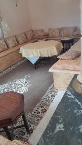 a living room with a couch and a table at Villa Tonsi in Sbiti +2 photos