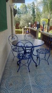 a glass table and chairs on a patio at Villa Tonsi in Sbiti