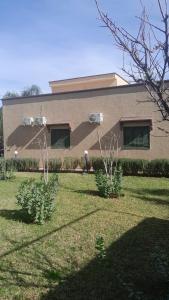 a house with two bushes in front of it at Villa Tonsi in Sbiti
