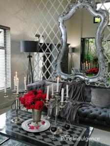 a living room with a couch and a mirror at Another World - Montagu in Montagu