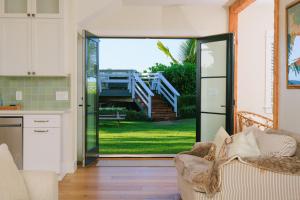a kitchen with a sliding glass door leading to a yard at The Emerald House II apts in Waialua