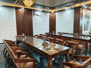 a conference room with wooden tables and chairs at Hotel Sanjay palace in Mahwah