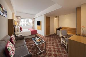 a hotel room with a couch and a bed at Fortune Park Galaxy, Vapi - Member ITC Hotels' Group in Vapi