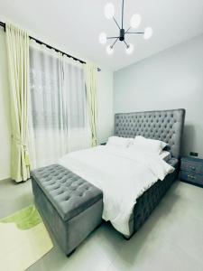 MunyonyoにあるMorganの大きなベッドと大きな窓のある寝室