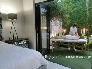 an image of a woman sitting on a bed in a bedroom at Another World - Montagu in Montagu