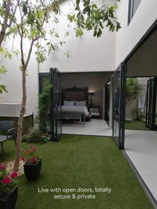 a bedroom with a bed and a yard with grass at Another World - Montagu in Montagu