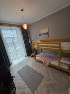 a bedroom with two bunk beds and a large window at ZIG ZAG apartment 4- Old Town in Constanţa
