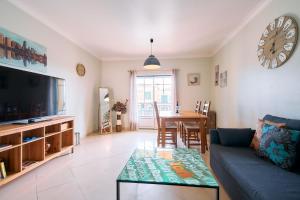 a living room with a couch and a table at Apartment Karin mit schönen Meerblick in Porches