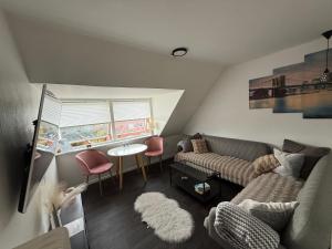 a living room with a couch and a table at Hel ændre men hyggelig lejlighed in Sønderborg