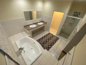 a bathroom with a tub and a toilet and a sink at Kloofyard Guesthouse in Pretoria +44 photos