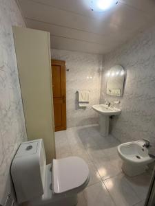 a bathroom with a toilet and a sink at Ajuda Mar Holidays in Funchal +11 photos