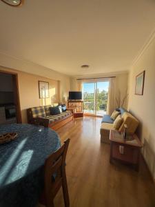 a living room with a couch and a table at Ajuda Mar Holidays in Funchal