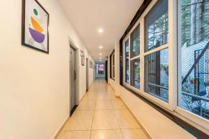 a corridor of a building with large windows at Treebo Premium Tranquil Inn in Shimla