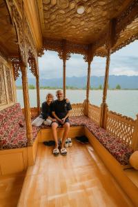 a man and a woman sitting on the back of a boat at Shanghai Palace in Srinagar