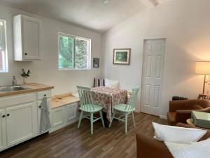 a kitchen and dining room with a table and chairs at The Black Bear Cabin in Klamath