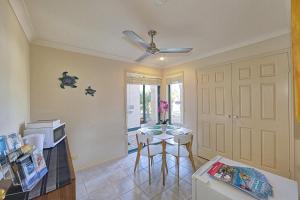 a kitchen with a small table and a microwave at Golden Cane Bed & Breakfast in Bargara