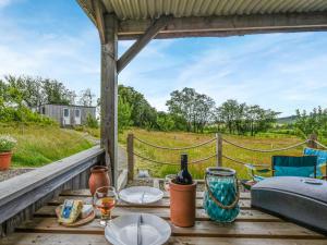 a table with glasses of wine and a view of a field at The Owl Pod - Uk50070 in Welshpool