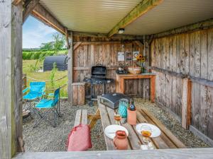 an outdoor kitchen with a table and a stove at The Owl Pod - Uk50070 in Welshpool