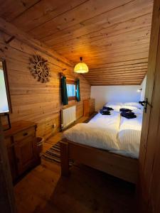 a bedroom with a bed in a wooden cabin at Trail & Tiefschnee Lodge in Reith im Alpbachtal