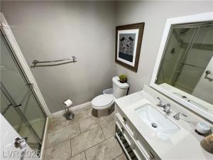 a white bathroom with a toilet and a sink at T-Designed to ENJOY!. Best Vacation in Las Vegas +10 photos