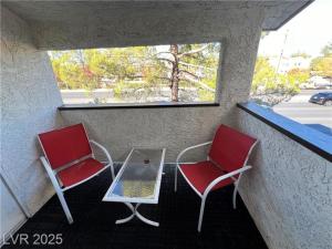 two red chairs and a table on a balcony at T-Designed to ENJOY!. Best Vacation in Las Vegas