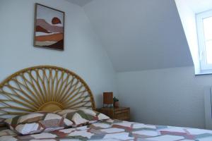 a bedroom with a bed with a fan on it at Apartee - Charmant T2 en centre ville de Laval in Laval