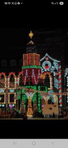 a christmas display of a house with christmas lights at Urban Retreat 1BDR Craiova in Bordeiu
