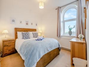 a bedroom with a large bed and a window at Toll Bar Cottage in Whitby