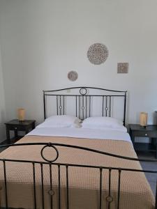 a bed in a room with two night stands and two tables at Marathos in Kanakis