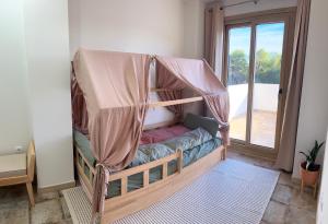 a bed with a canopy in a room with a window at Casa Milivan Spacious Family Villa with Private Pool in Las Villas +33 photos