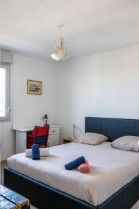 a bedroom with two beds and a red chair at Ô Cocon Paisible - WiFi, Calme, Smart TV, Parking - A 2min du Campus TBS in Quint-Fonsegrives