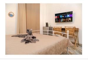 a bedroom with a bed with a teddy bear on it at Le case nel vicolo rooms in Alghero +4 photos