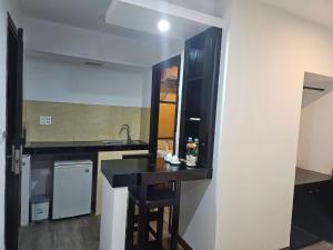 a kitchen with a black counter and a sink at SAM Hotel and Apartment in Da Nang +18 photos