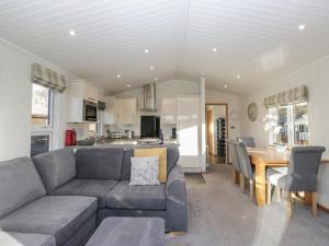 a living room with a couch and a table at Bluebell Lodge in Carnforth
