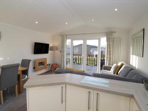 a living room with a couch and a table at Bluebell Lodge in Carnforth