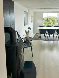sala de estar con chimenea y comedor en Family-Friendly Holiday Home Near Hasmark Beach, en Kristiansminde 12 fotos más