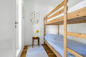 a bedroom with two bunk beds and a lamp at Modern Archipelago Cabin With Hot Tub On Timrarön in Vadholma