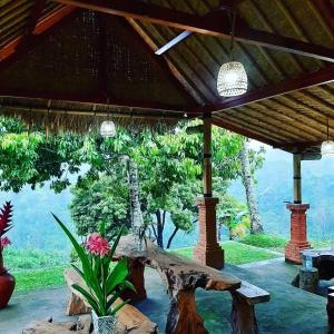 a patio with a table and a view of the mountains at Wana Ayu Jelijih Villas in Tampaksiring +2 photos
