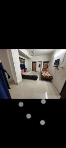 a room with two beds and a tv in it at Gurukrupa Home stay in Rājpīpla