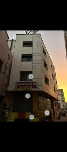 a tall building with white lights on top of it at Gurukrupa Home stay in Rājpīpla