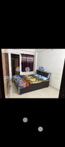 a bedroom with a large bed in a room at Gurukrupa Home stay in Rājpīpla