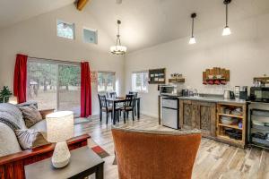a kitchen and living room with a couch and a table at Kalispell Cabin 28 Miles to Glacier National Park! in Kalispell