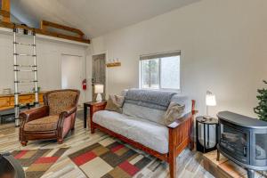 a living room with a couch and a fireplace at Kalispell Cabin 28 Miles to Glacier National Park! in Kalispell